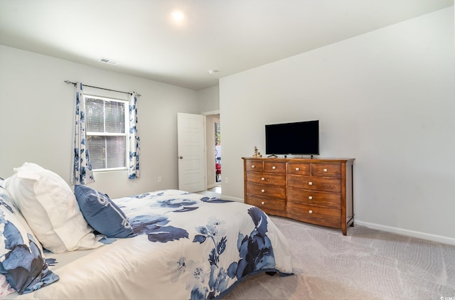 bedroom featuring light carpet, baseboards, and visible vents