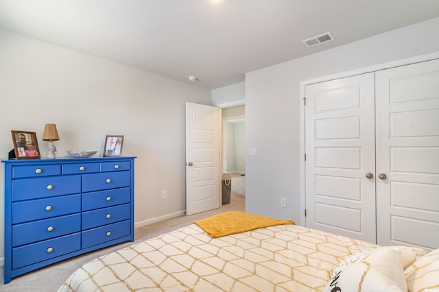 bedroom with light colored carpet, a closet, visible vents, and baseboards