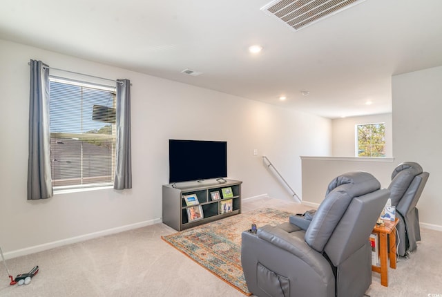 living room featuring light carpet, baseboards, and visible vents