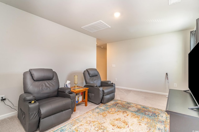 sitting room with light carpet, visible vents, and baseboards