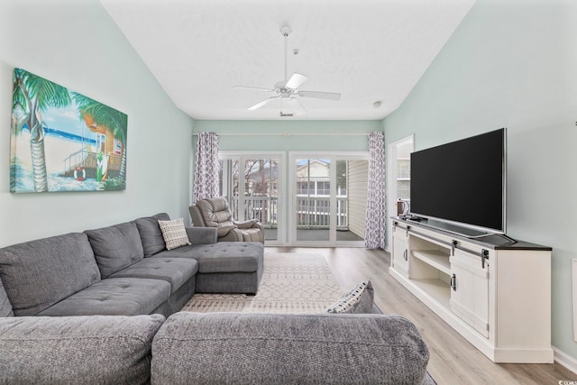 living room with ceiling fan, light wood-type flooring, and baseboards