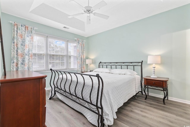 601 N Hillside Dr Unit 4632, North Myrtle Beach, SC 29582 - bedroom with wood finished floors, baseboards, a ceiling fan, and a raised ceiling