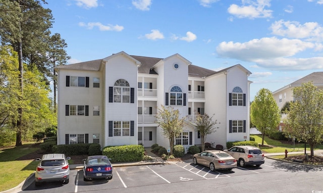 view of building exterior with uncovered parking