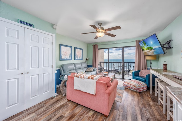 living room featuring a ceiling fan and wood finished floors