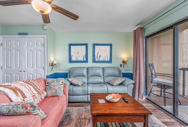 living room with a ceiling fan and wood finished floors