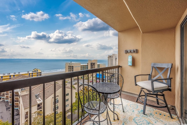 balcony with a beach view and a water view