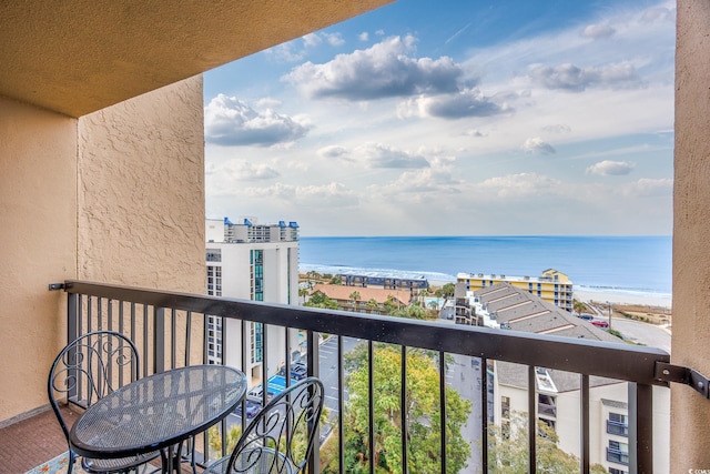 balcony with a beach view and a water view