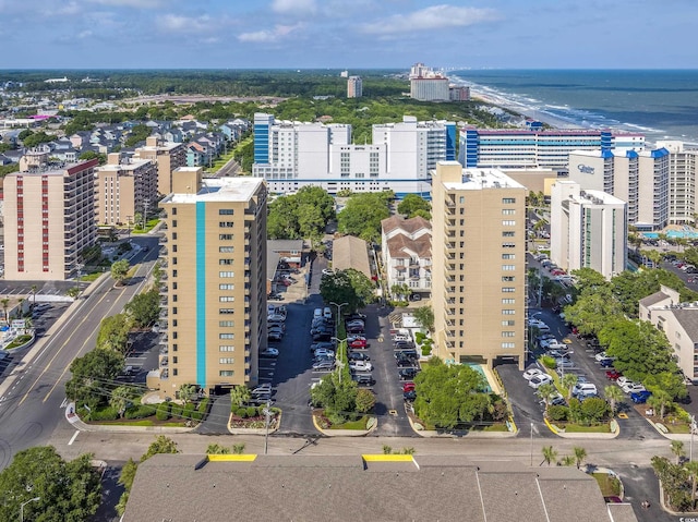 birds eye view of property featuring a water view and a city view