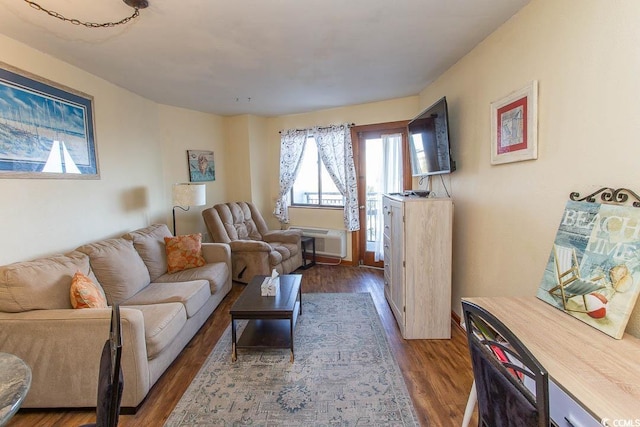 living area with dark wood finished floors and a wall mounted air conditioner