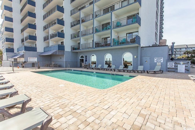 pool featuring a patio area and fence