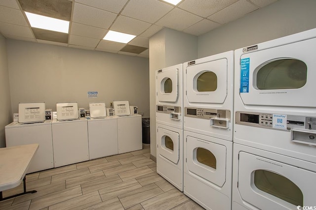 common laundry area with wood tiled floor, stacked washer and clothes dryer, and washer and dryer