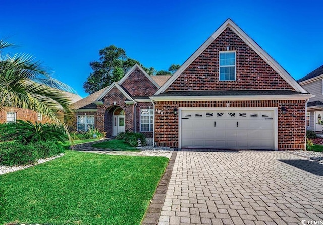 traditional-style home with a garage, decorative driveway, brick siding, and a front lawn