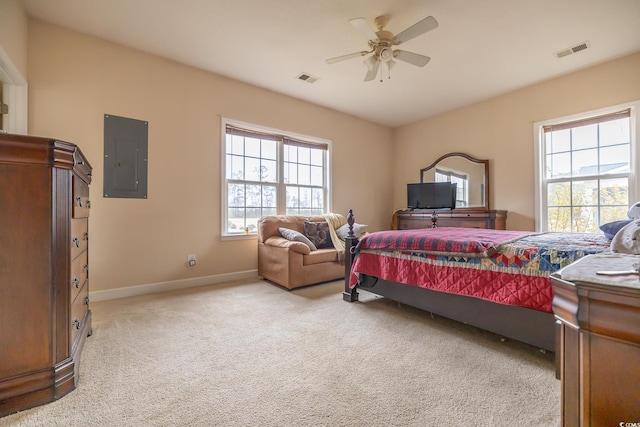 bedroom with baseboards, electric panel, visible vents, and light colored carpet