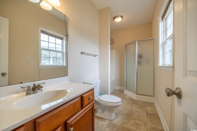 bathroom featuring toilet, vanity, baseboards, a shower stall, and tile patterned floors