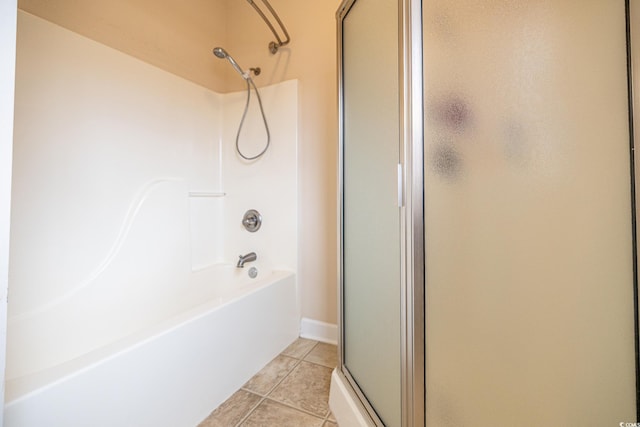 bathroom featuring a stall shower, tile patterned flooring, and a bath