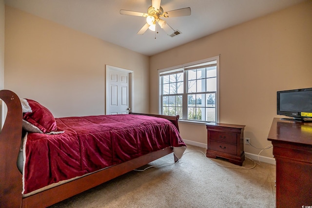 bedroom featuring baseboards, visible vents, a ceiling fan, and light colored carpet