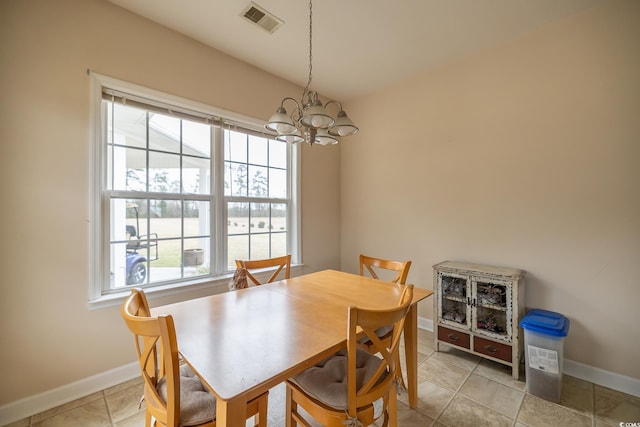 dining room with an inviting chandelier, visible vents, baseboards, and light tile patterned flooring