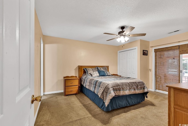 bedroom with a textured ceiling, light colored carpet, visible vents, access to exterior, and baseboards