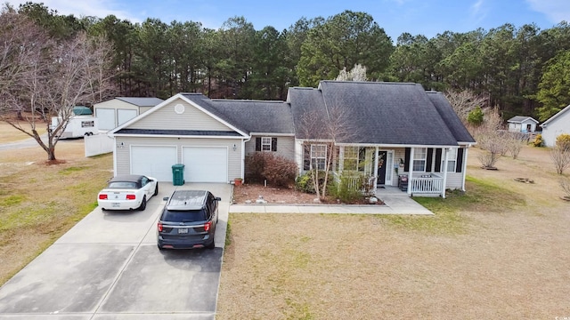 view of front facade featuring a garage, concrete driveway, a porch, and a front yard