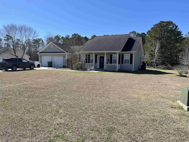 view of front of home featuring covered porch, a front lawn, and an attached garage