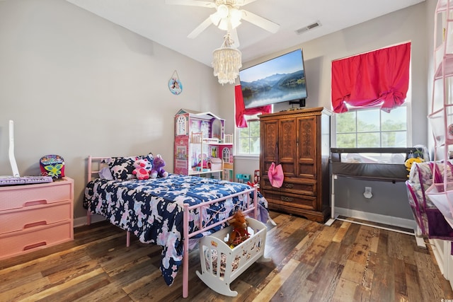 bedroom with visible vents and hardwood / wood-style floors