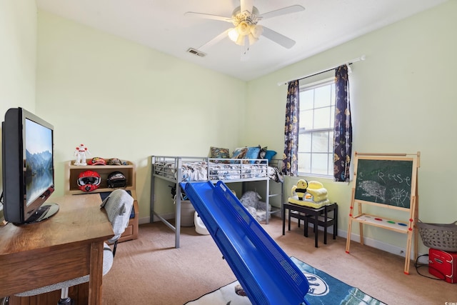 carpeted bedroom featuring baseboards, visible vents, and a ceiling fan