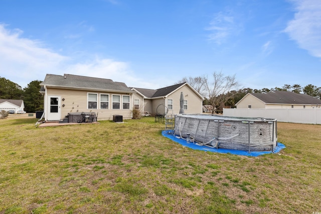 back of house with a fenced in pool, a lawn, a patio, and fence