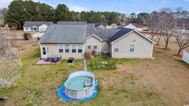 rear view of house with a patio and a lawn