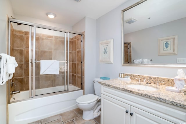 full bath featuring visible vents, bath / shower combo with glass door, vanity, and toilet