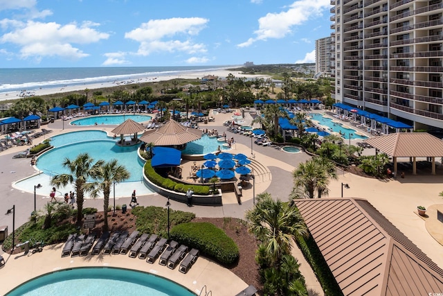 birds eye view of property with a water view and a view of the beach