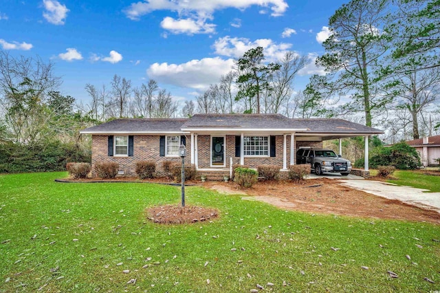 ranch-style home with brick siding, concrete driveway, a front yard, crawl space, and an attached carport