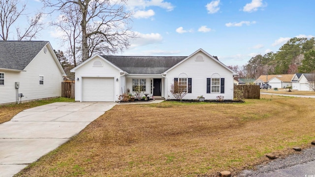 view of front of home with an attached garage, fence, a front lawn, and concrete driveway