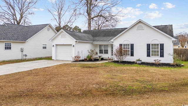 ranch-style house featuring a garage, driveway, a front lawn, and a shingled roof