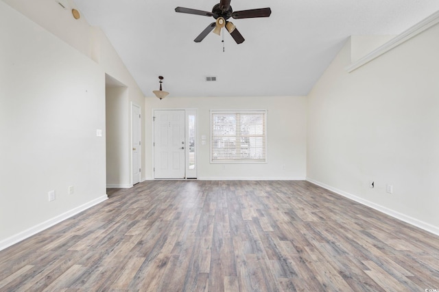 unfurnished living room featuring lofted ceiling, wood finished floors, visible vents, and baseboards