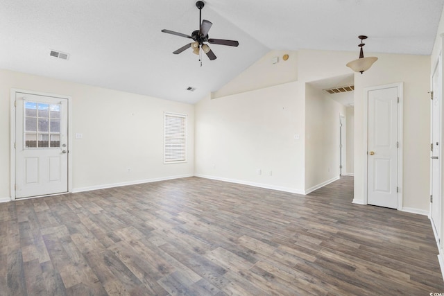 unfurnished room featuring vaulted ceiling, dark wood-type flooring, visible vents, and a ceiling fan