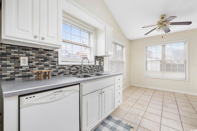 kitchen featuring lofted ceiling, white cabinetry, white dishwasher, a sink, and light tile patterned flooring