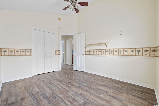 spare room with high vaulted ceiling, ceiling fan, and wood finished floors