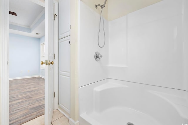 full bathroom with ornamental molding, walk in shower, tile patterned flooring, and baseboards