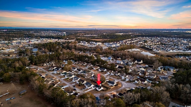 aerial view at dusk featuring a residential view