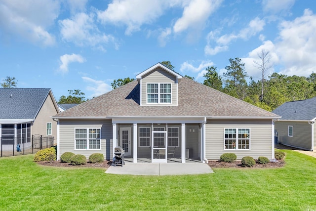 back of property featuring a patio, fence, a sunroom, a yard, and roof with shingles