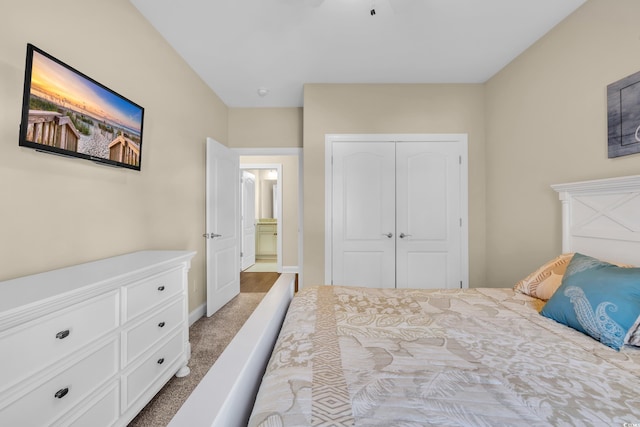 bedroom with a closet, carpet flooring, and baseboards