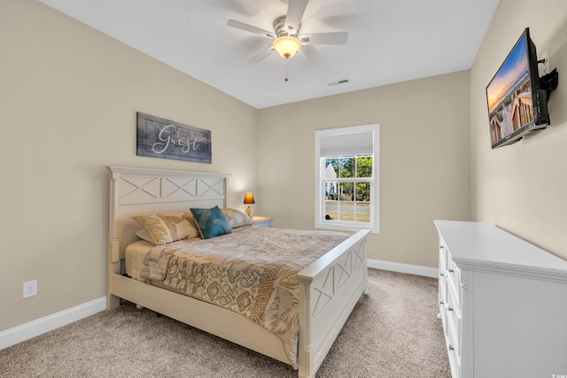 bedroom featuring light carpet, baseboards, visible vents, and a ceiling fan