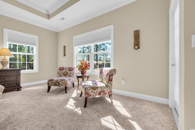 living area featuring ornamental molding, light colored carpet, and baseboards