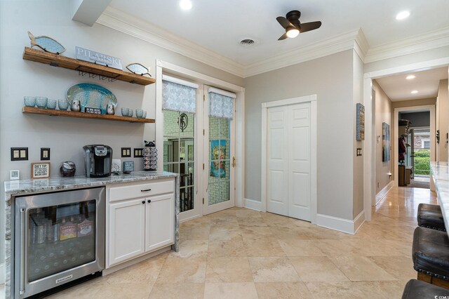 3100 Lahinch Dr, Myrtle Beach, SC 29579 - bar with beverage cooler, visible vents, baseboards, crown molding, and a bar