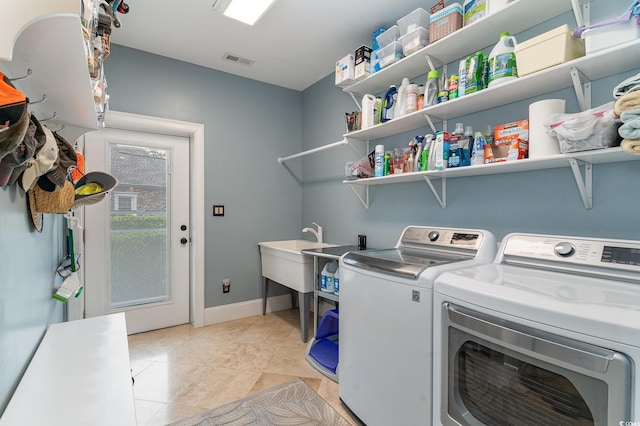 3100 Lahinch Dr, Myrtle Beach, SC 29579 - laundry room with laundry area, baseboards, visible vents, washing machine and clothes dryer, and a sink