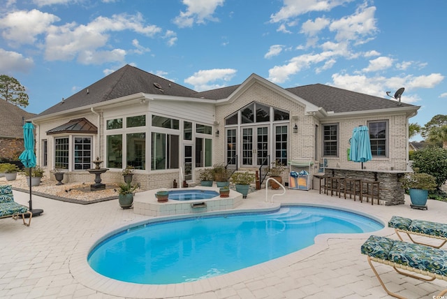3100 Lahinch Dr, Myrtle Beach, SC 29579 - rear view of property featuring a patio area, brick siding, outdoor dry bar, and an in ground hot tub