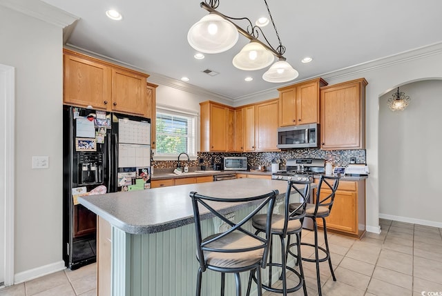 3600 White Wing Cir, Myrtle Beach, SC 29579 - kitchen with stainless steel microwave, crown molding, a kitchen island, light tile patterned floors, and decorative backsplash