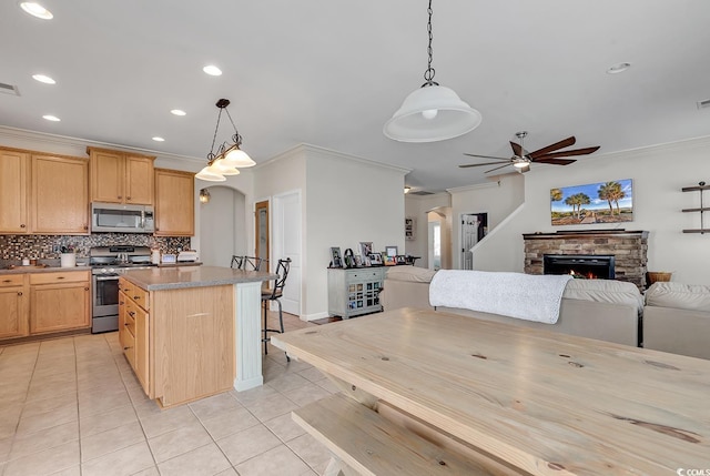 3600 White Wing Cir, Myrtle Beach, SC 29579 - kitchen featuring appliances with stainless steel finishes, ceiling fan, ornamental molding, light tile patterned floors, and backsplash