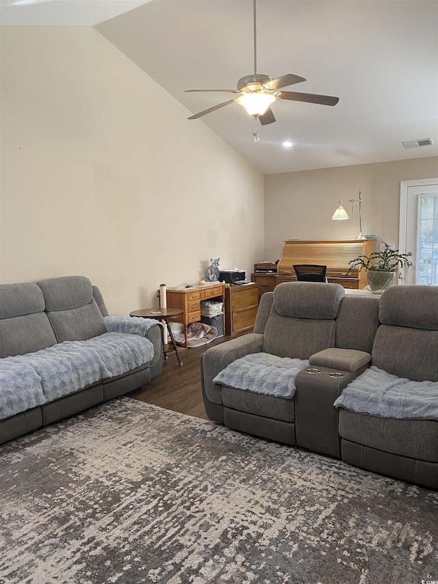 living room with a ceiling fan, visible vents, vaulted ceiling, and dark wood-type flooring