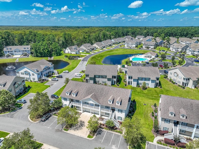 birds eye view of property with a water view and a residential view